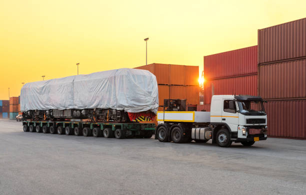 heavy oversize cargo truck loading a new locomotive